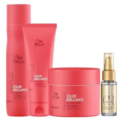 Shampoo, um condicionador e uma máscara de tratamento, todos em embalagens cilíndricas na cor rosa vibrante. Há também um frasco menor de vidro dourado de um óleo capilar.