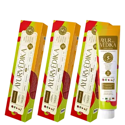 Três caixas de pasta de dente da marca Ayurvedika. Cada caixa possui um rótulo com o nome da marca "Ayurvedika" e informações sobre o produto.