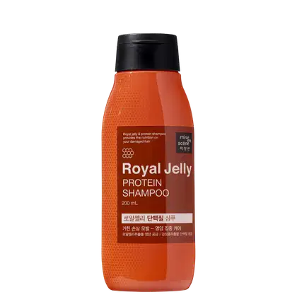 Frasco de shampoo de geléia real e proteína da marca Mise en Scène, com 200 ml de capacidade. O recipiente possui uma superfície laranja brilhante, com rótulo em preto e marrom destacando os ingredientes principais.