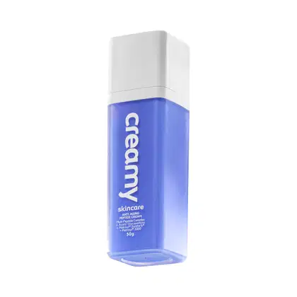 Frasco branco e azul de creme anti-envelhecimento da marca Creamy, com texto "Skincare Anti Aging Peptide Cream" e informações sobre os ingredientes na embalagem.