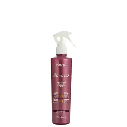 Spray fixador de cachos da linha Pro-Cachos da marca Essendy. A embalagem é um frasco plástico rosa com um rótulo branco e amarelo, contendo informações sobre o produto. O frasco possui um gatilho branco para aplicação do spray.
