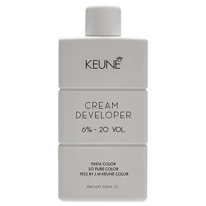 Frasco de creme revelador da marca Keune, com 6% a 20% de volume, em embalagem branca com logotipo da marca e informações sobre o produto impressas.