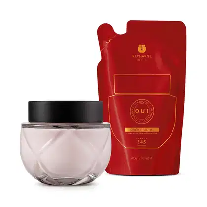 Creme hidratante desodorante da marca O.U.i. em embalagem vermelha com detalhes em dourado, contendo 200g do produto. O frasco de vidro transparente com tampa preta completa o conjunto.