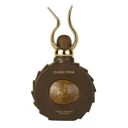 Frasco de perfume da linha Classic Stone da Niche Emarati, com formato arredondado e detalhes dourados, exibindo uma pedra central em tom marrom.
