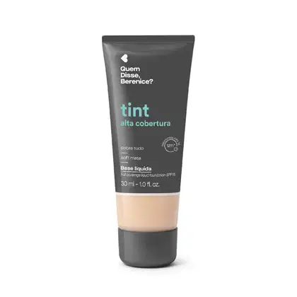 Bisnaga cinza escura com faixa bege de base líquida da marca Quem Disse, Berenice? com acabamento soft mate, com texto em destaque na cor azul indicando "tint alta cobertura".
