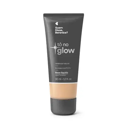 Bisnaga cinza de base líquida da marca Tô no Glow Quem disse, Berenice?, com detalhe na cor da base na parte inferior da embalagem e texto branco branco no rótulo.