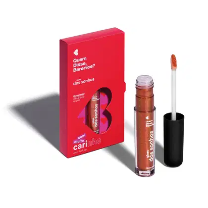 Caixa vermelha com texto em branco contendo um gloss labial da marca Quem Disse, Berenice? em embalagem preta com detalhes dourados. O produto possui 4 ml e é descrito como "com muito carinho".