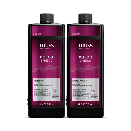 Dois frascos de 1L da linha Color Shield da Truss Professional, contendo shampoo e condicionador para proteção da cor dos cabelos. Embalagens pretas com detalhes em roxo, exibindo o nome da marca e do produto.