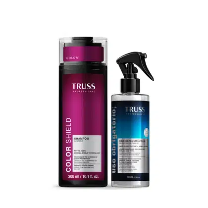 Dois produtos da marca TRUSS Professional: um frasco de shampoo de cor rosa e um frasco spray de reconstrutor capilar de cor azul, ambos com rótulos e embalagens característicos da marca.