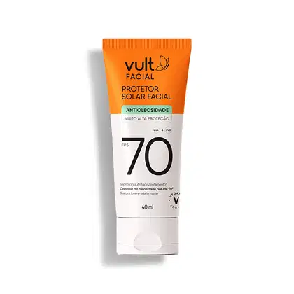 Protetor solar facial em embalagem plástica tubular de cor laranja e branca.