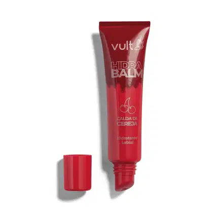 Tubo vermelho de hidratante labial da marca Vult com aplicador embutido. Rótulo em cores douradas com o texto Calda de Cereja em destaque. Embalagem com tampa vermelha, apresentando o nome do produto "Hidra Balm" em destaque.