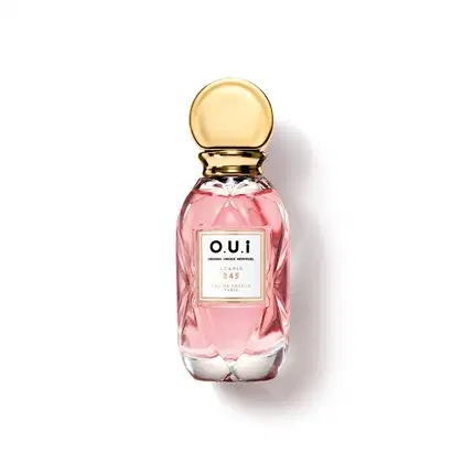 Frasco de perfume O.U.i. Scapin 245, com embalagem de vidro rosa e tampa dourada. Rótulo com o nome da marca e informações sobre o produto.