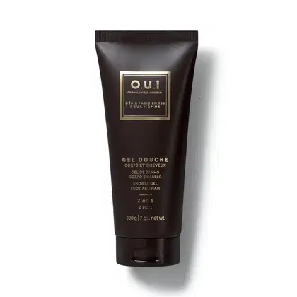 Frasco preto de gel de banho da marca O.U.i, com rótulo dourado em formato retangular contendo informações sobre o produto.