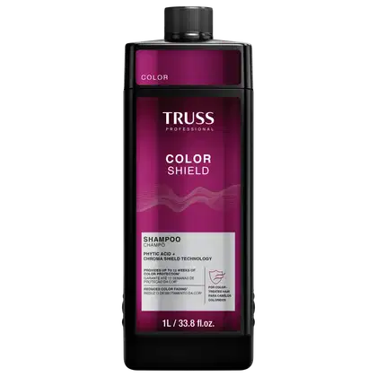 Frasco de item de perfumaria preto e rosa com rótulo "TRUSS PROFESSIONAL COLOR SHIELD". O frasco possui formato cilíndrico com tampa preta. O rótulo apresenta o nome da marca em letras brancas e informações sobre o produto em texto rosa e branco.