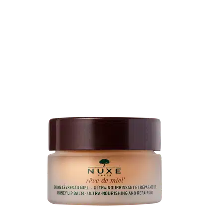 Hidratante labial da marca Nuxe. Embalagem de vidro transparente com tampa marrom escura. Rótulo bege com o logotipo da marca em verde e o nome do produto "rêve de miel" (sonho de mel).