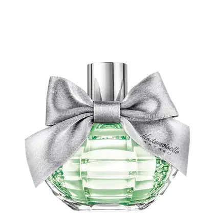 Frasco de perfume Azzaro com laço prateado, contendo líquido verde claro, embalado em recipiente de vidro facetado com tampa metálica.