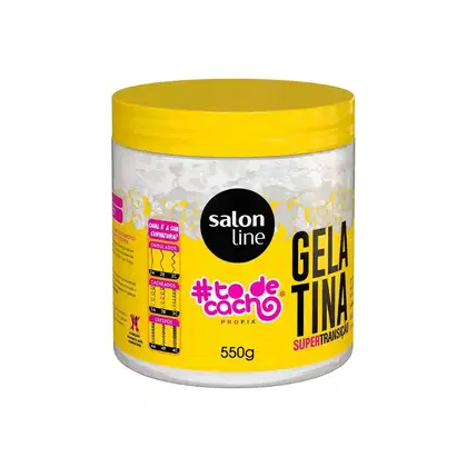 Pote de gel capilar da linha Salon Line, com tampa amarela e rótulo com o nome "#todecacho" em destaque. Embalagem de 550g, com informações sobre o produto "Gelatina Supertransição" impressas.