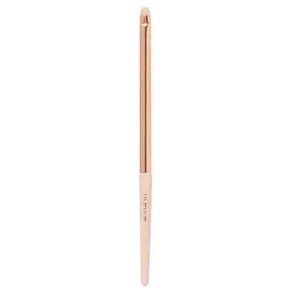 Pincel de maquiagem em formato cilíndrico alongado. Cabo e extremidades na cor bege claro. Parte central do cabo em tom rosado metálico. Inscrição "Océane" visível em uma das extremidades. Design simples e minimalista.