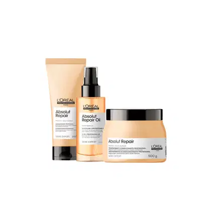 A linha de produtos Absolut Repair da L'Oréal Professionnel, incluindo um creme condicionador, um óleo reparador e uma embalagem de tratamento profissional, todos em embalagens com design minimalista e cores neutras.