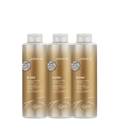Três frascos de shampoo reconstrutor Joico K-Pak, com embalagem em tons dourados e brancos, exibindo o nome da marca e a descrição do produto.