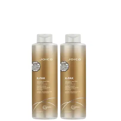 Dois frascos de shampoo reconstrutor Joico K-Pak, com embalagem em tons dourados e brancos, apresentando rótulos com o nome da marca e informações sobre o produto.