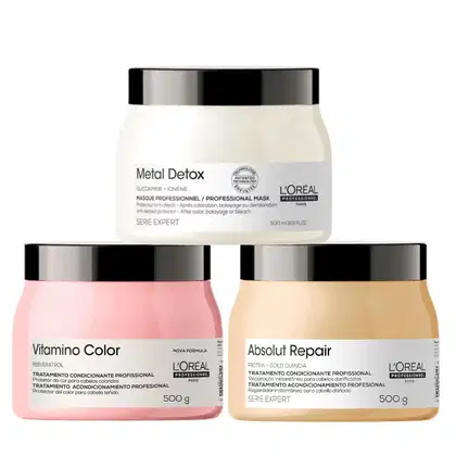 Três produtos de tratamento de cabelo da L'Oréal Professionnel: Metal Detox em embalagem branca e preta, Vitamino Color em embalagem rosa e Absolut Repair em embalagem amarela, todos com 500 g.