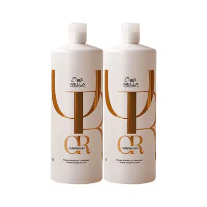 Dois frascos brancos de 1 litro da linha Oil Reflections da Wella Professionals, com detalhes em dourado no rótulo e logotipo da marca.