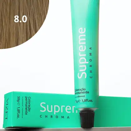 A imagem mostra a embalagem em tubo plástico verde claro com o nome da marca e produto impresso. Caixa retangular verde com detalhes do produto, incluindo a cor e o volume de 50g. No canto superior há uma pequena mecha com o tom da coloração.