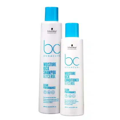 Dois frascos brancos da linha Bonacure da Schwarzkopf Professional, um com tampa azul (Moisture Kick Shampoo) e outro com tampa azul (Moisture Kick Conditioner), ambos com rótulos indicando os produtos e suas características.