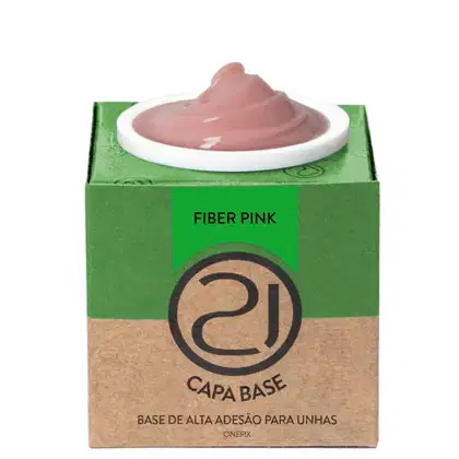 A imagem mostra uma base de alta adesão para unhas. O produto vem em uma embalagem retangular de papelão verde e marrom. No centro, há um recipiente branco contendo o produto, que parece ser um gel em tom nude.