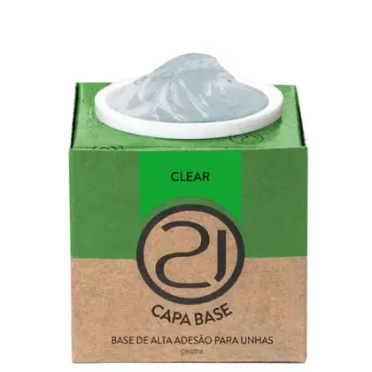 A imagem mostra uma base de alta adesão para unhas. O produto vem em uma embalagem retangular de papelão verde e marrom. No centro, há um recipiente branco contendo o produto, que parece ser um gel transparente.