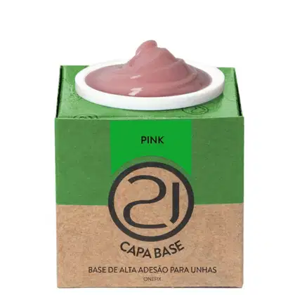A imagem mostra uma base de alta adesão para unhas. O produto vem em uma embalagem retangular de papelão verde e marrom. No centro, há um recipiente branco contendo o produto, que parece ser um gel em tom rosa.