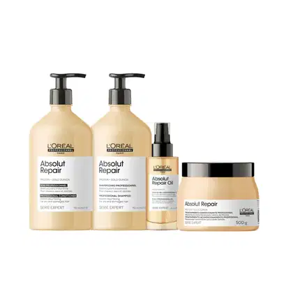A imagem mostra um kit com 4 produtos de L'Oréal Professionnel da linha Absolut Repair, sendo dois frascos cilíndricos grandes de shampoo e condicionador, um frasco menor de óleo capilar e um pote redondo de máscara. Todos na cor amarelo claro.