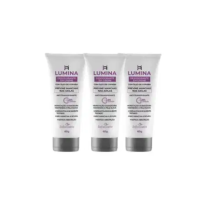Três tubos de creme desodorante da marca Lumina, com 60g cada, contendo óleo de copaíba para prevenir manchas nas axilas. Embalagens brancas com detalhes em roxo, destacando propriedades antitranspirantes e hidratação duradoura.