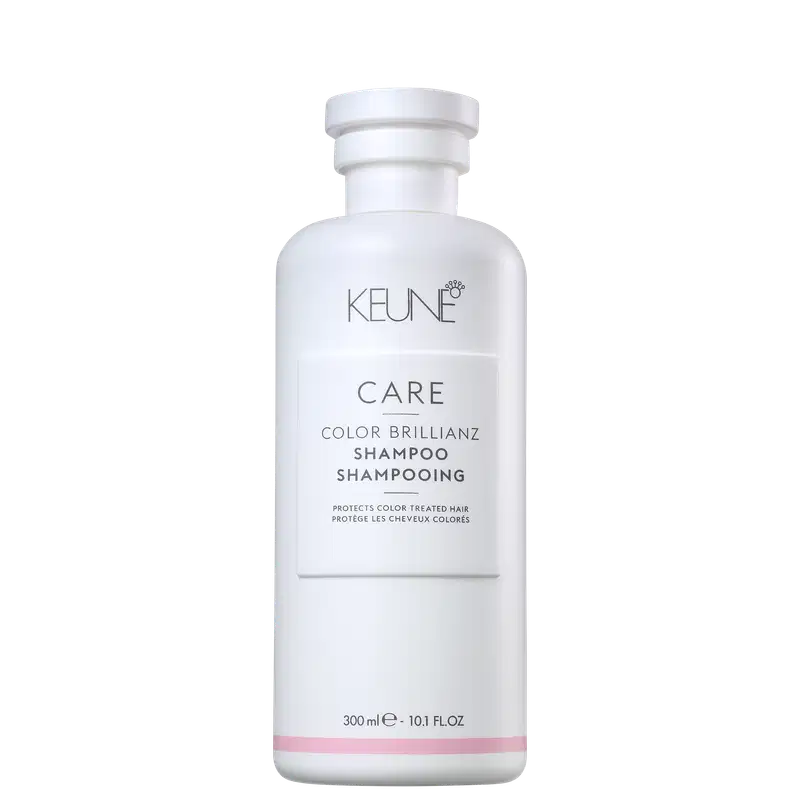 Frasco branco da linha Care da Keune, contendo Shampoo Color Brillianz para proteção de cabelos coloridos. Rótulo com nome do produto e informações sobre sua função de proteger a cor dos cabelos.