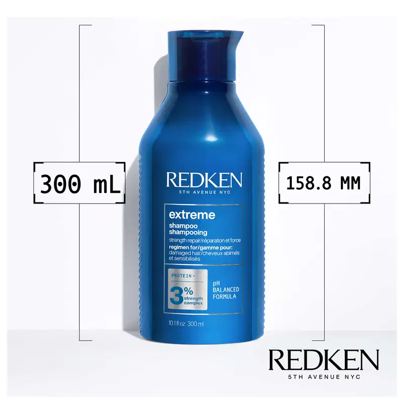 Frasco de shampoo Redken Extreme de 300 ml, com design azul e branco, rótulo com informações sobre o produto e sua fórmula balanceada de pH.