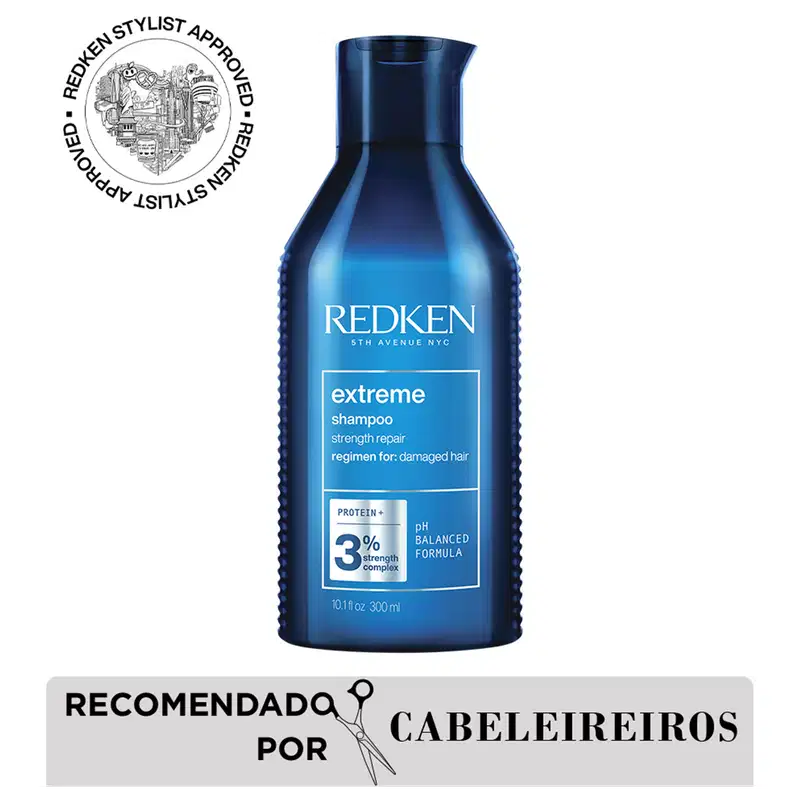Frasco de shampoo Redken Extreme, com design azul degradê, rótulo com informações sobre o produto e selo de aprovação de cabeleireiros. Produto destinado a cabelos danificados, com fórmula de 3% de complexo de proteínas.
