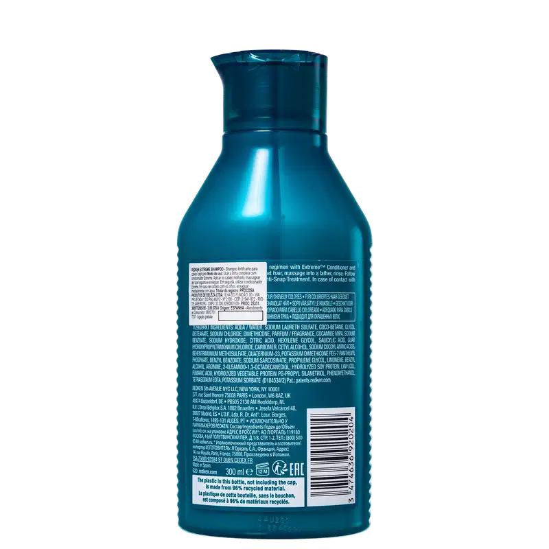 Frasco de shampoo Redken Extreme de 300 ml, com embalagem de plástico azul-esverdeado brilhante. O rótulo apresenta informações sobre o produto e sua composição.