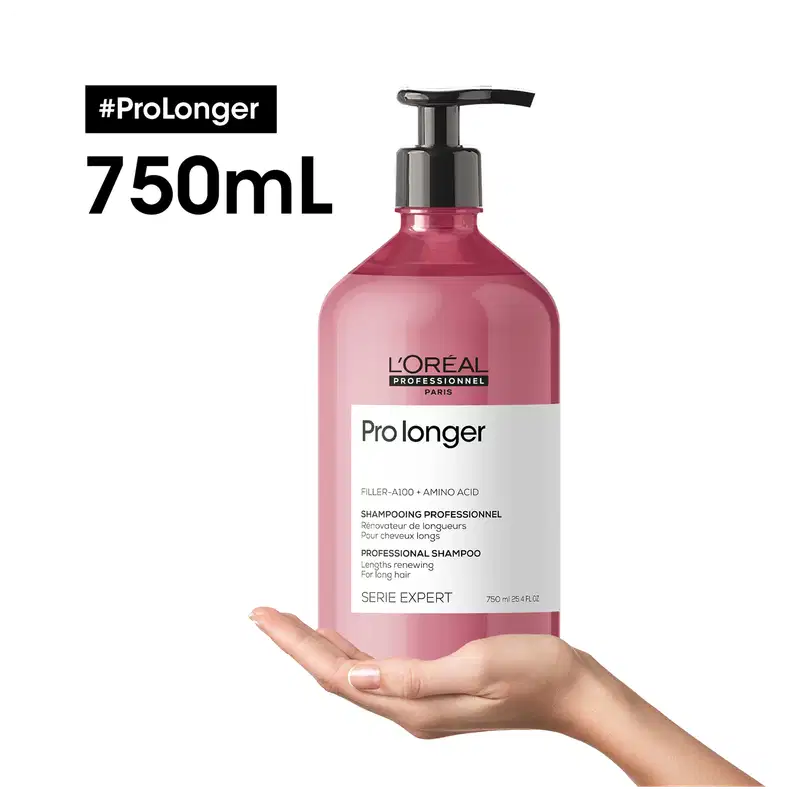 Frasco de plástico rosa com bomba preta, contendo 750 ml de shampoo profissional da marca L'Oréal Professionnel, da linha Pro Longer, para cabelos longos. O rótulo apresenta o nome do produto e informações sobre seus ingredientes e benefícios.