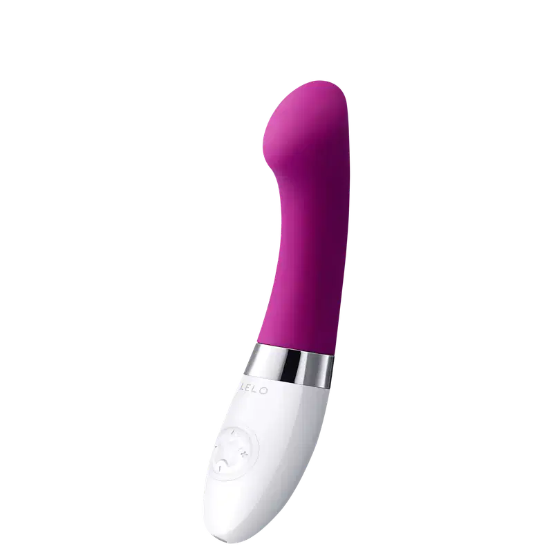 Este é um vibrador pessoal de silicone na cor roxa intensa. Possui um formato alongado e arredondado em uma extremidade. A base é branca e apresenta o logotipo "LELO" gravado. Há também alguns botões ou controles visíveis na base branca.