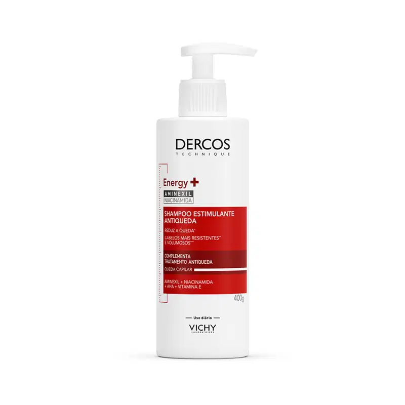 Frasco branco com bomba doseadora da marca Dercos, contendo shampoo estimulante antiqueda com aminexil, niacinamida e vitamina E, complemento do tratamento antiqueda.