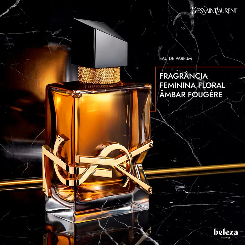 Frasco de perfume Yves Saint Laurent com design elegante em preto e dourado. Recipiente de vidro transparente contendo líquido âmbar, com tampa e detalhes metálicos dourados. Rótulo com logotipo da marca em destaque.