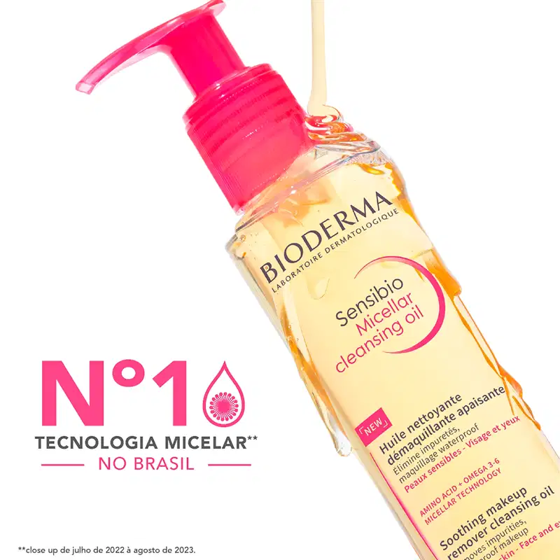 Frasco de item de perfumaria da marca Bioderma com bomba doseadora vermelha, contendo óleo micelar para limpeza da pele, com texto "Sensibio Micellar Cleansing Oil" visível.