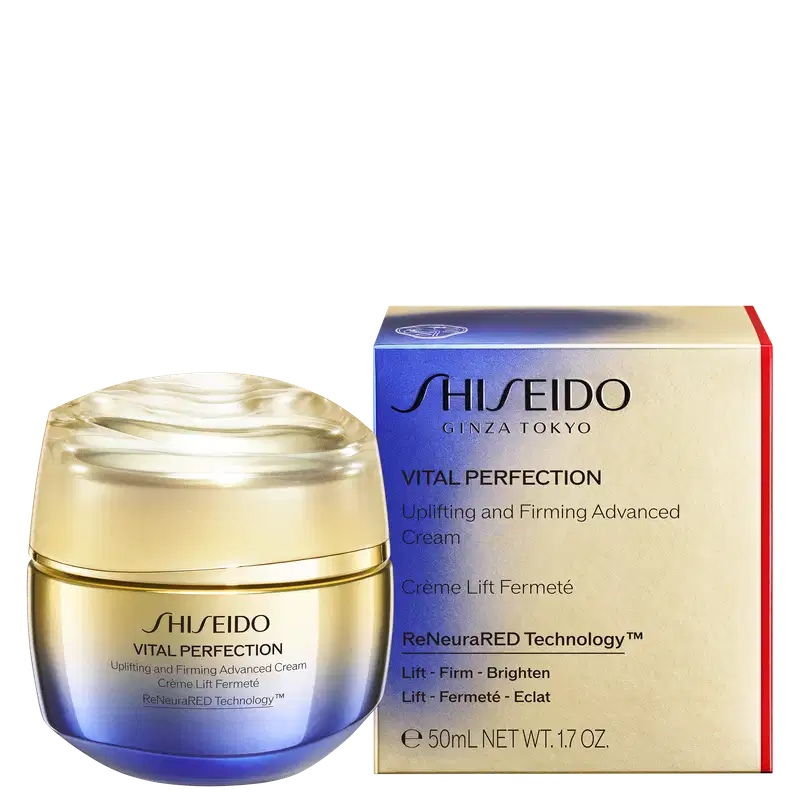 Produto de cuidados com a pele da marca Shiseido, linha Vital Perfection. Creme lifting e firmador avançado em embalagem dourada com tampa plástica transparente. Caixa retangular azul e vermelha com detalhes em prateado.