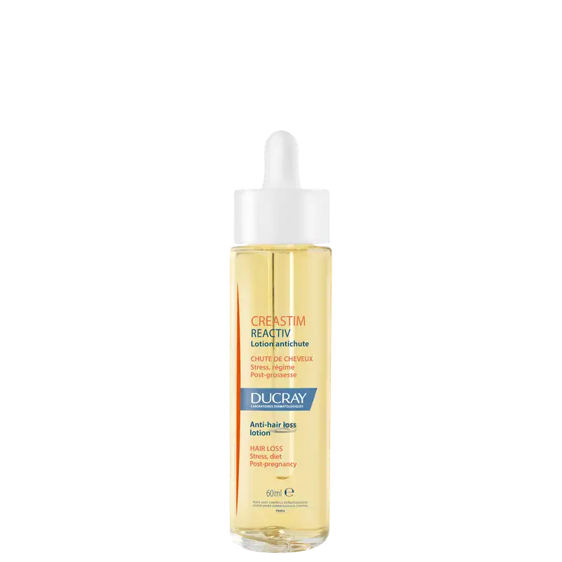 A imagem mostra um frasco transparente contendo um líquido amarelo claro. É o "Creastim Reactiv", da marca Ducray. Trata-se de uma loção antiqueda de cabelo. O frasco tem um aplicador em formato de conta-gotas na parte superior e 60ml de produto.