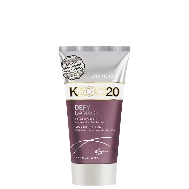 A embalagem é um tubo plástico roxo, branco e prateado com detalhes em dourado. O rótulo frontal apresenta o nome do produto e informações como "para fortalecer e criar ligações".