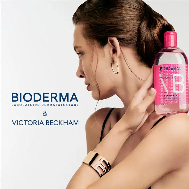 Embalagem rosa da marca Bioderma, com texto "Sensibio H2O" e "Victoria Beckham" visíveis.