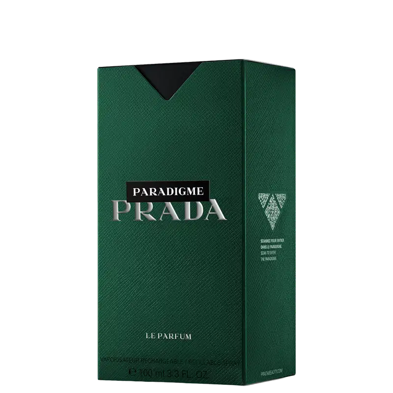 Caixa verde escura com o logotipo da Prada em branco e prata, contendo um frasco de perfume Paradigme da marca. A embalagem apresenta uma textura de couro sintético e o rótulo indica que se trata de um "Le Parfum" com 100 ml de conteúdo.