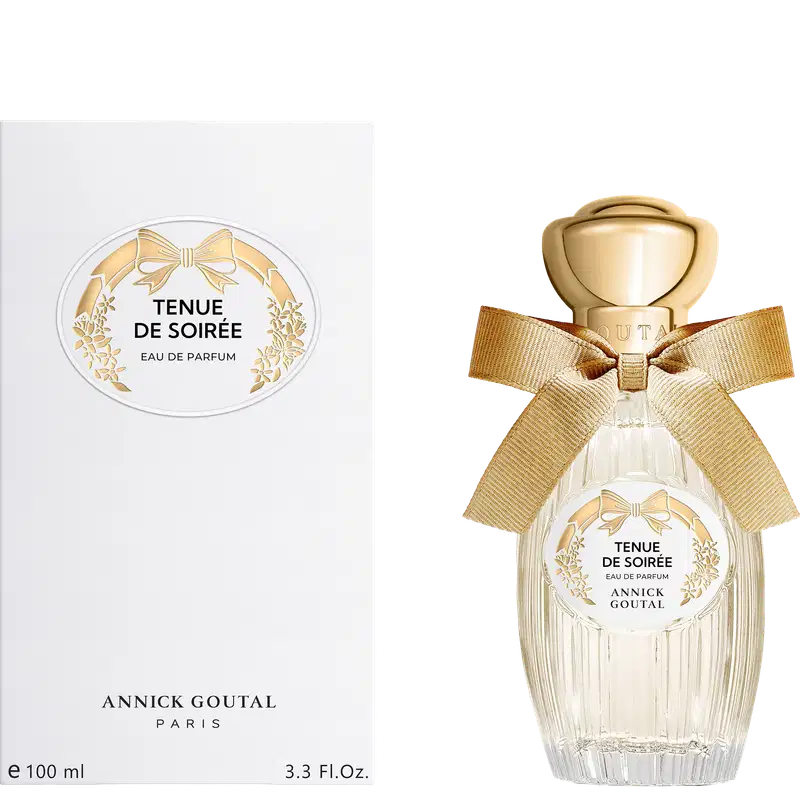 Eau de Parfum Tenue de Soirée da Annick Goutal Paris. Frasco de vidro cristalino com tampa dourada e laço de fita bege. Caixa branca com rótulo oval decorado com laço e flores douradas. Volume 100ml.