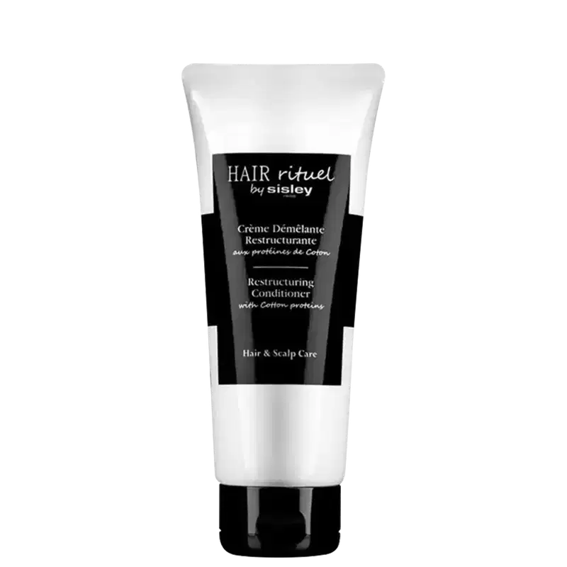 Condicionador da marca Sisley, chamado "Hair rituel". O rótulo indica que se trata de um condicionador reestruturante com proteínas de algodão. O produto é apresentado em um tubo plástico com tampa.